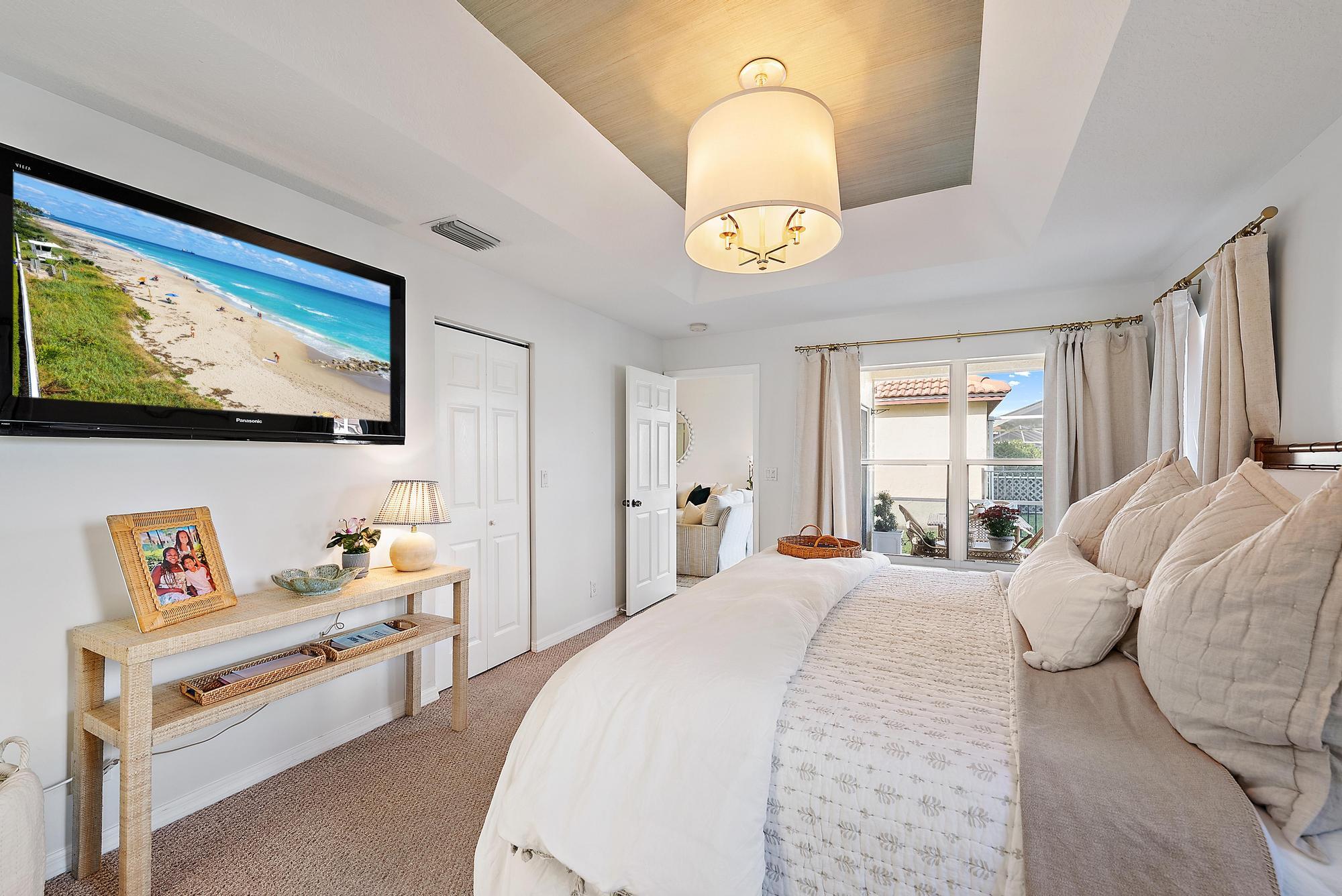 5010 Elpine Way Riviera Beach, FL 33418 - Photo 12 of 27 a bedroom with a bed and a flat screen tv