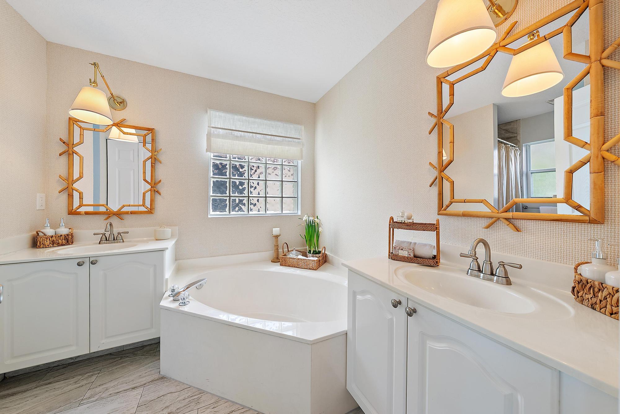 5010 Elpine Way Riviera Beach, FL 33418 - Photo 13 of 27 a bathroom with a tub sink and mirror