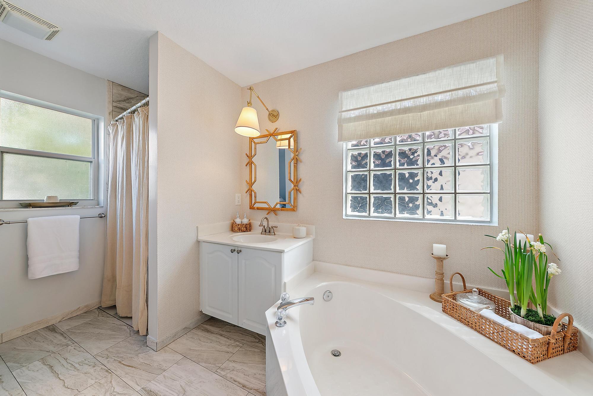 5010 Elpine Way Riviera Beach, FL 33418 - Photo 14 of 27 a bathroom with a tub sink and mirror