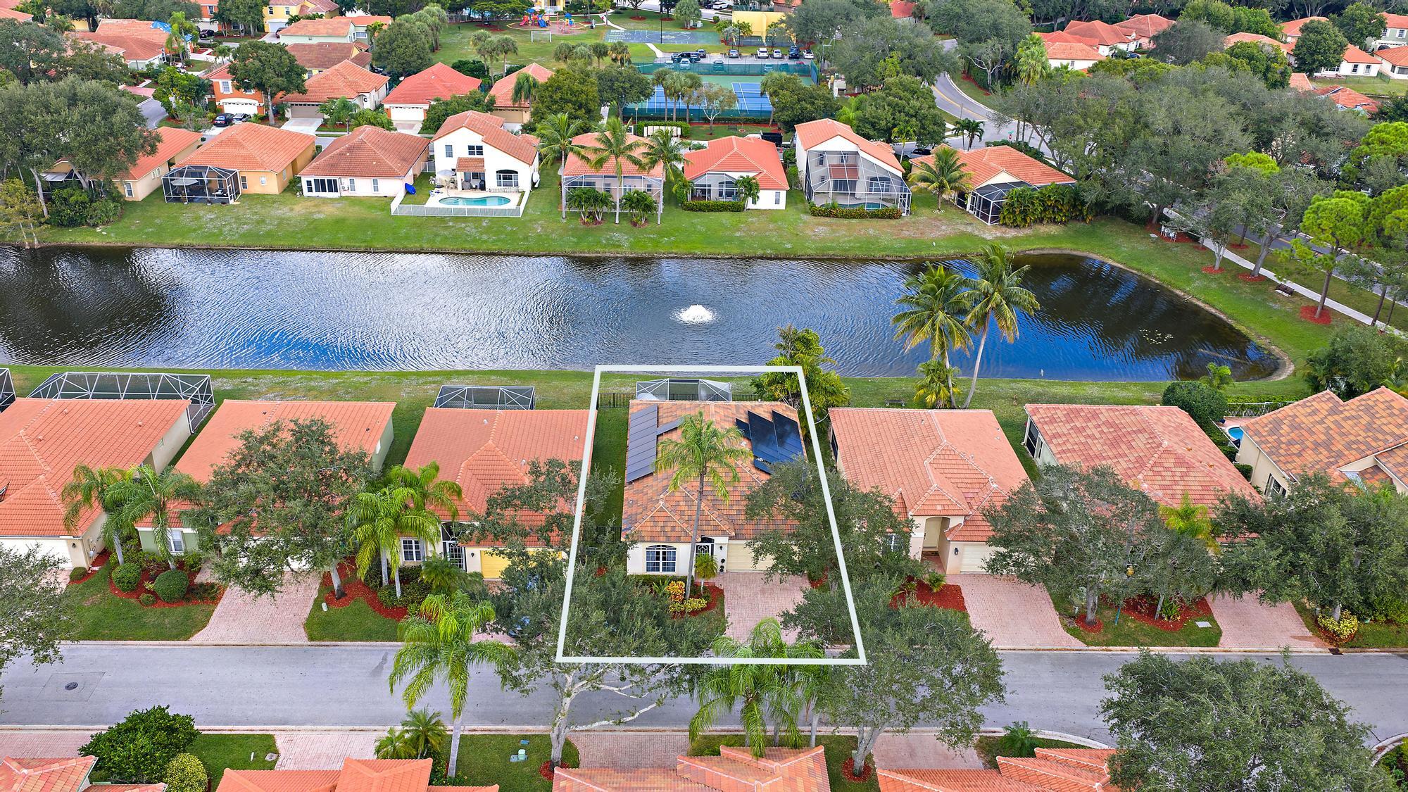 5010 Elpine Way Riviera Beach, FL 33418 - Photo 22 of 27 an aerial view of swimming pool with outdoor seating and lots of flowers