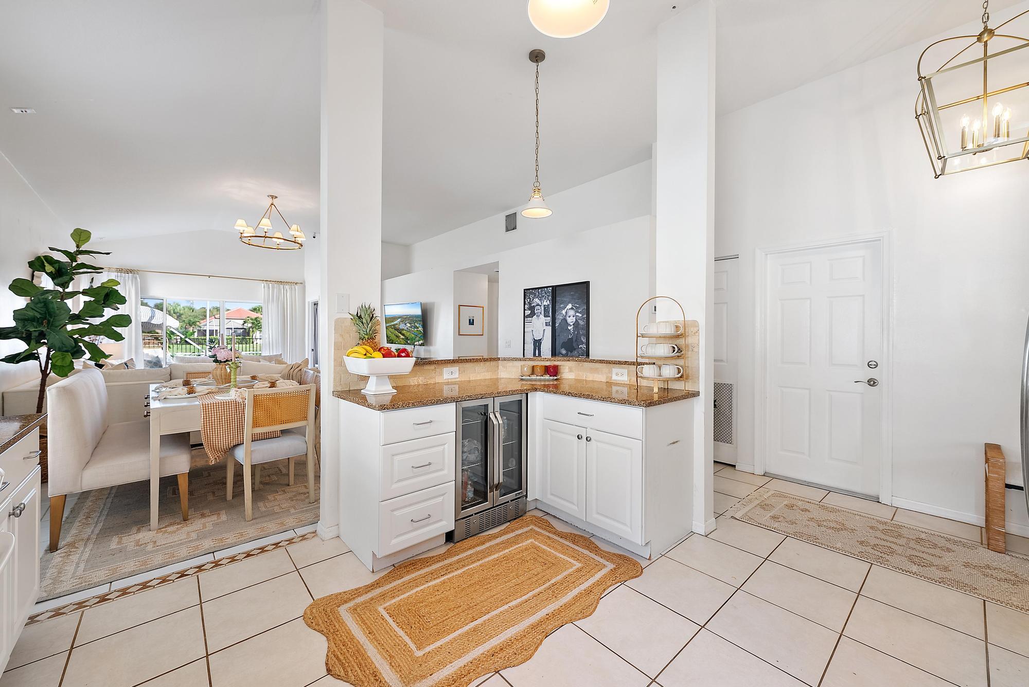 5010 Elpine Way Riviera Beach, FL 33418 - Photo 5 of 27 a room with kitchen island granite countertop furniture and a fireplace