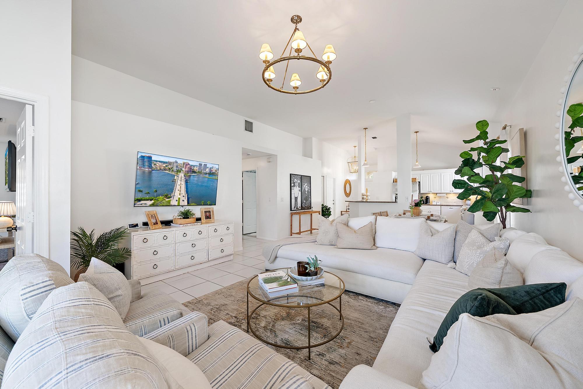 5010 Elpine Way Riviera Beach, FL 33418 - Photo 9 of 27 a living room with furniture and a large mirror