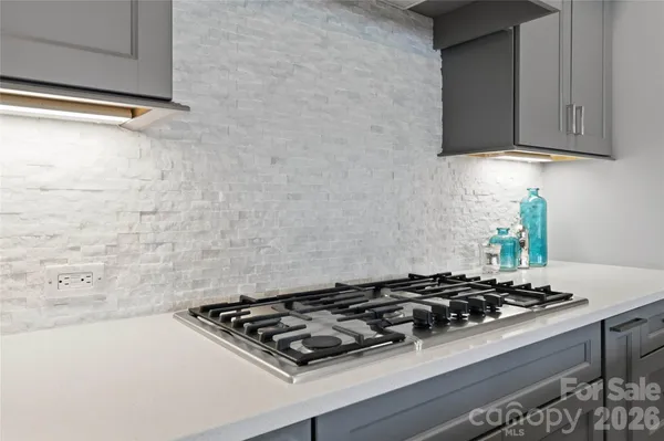 a stove top oven sitting inside of a kitchen