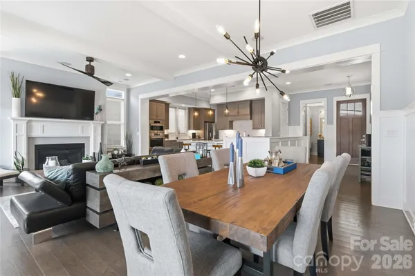 a view of a dining room with furniture a rug and wooden floor