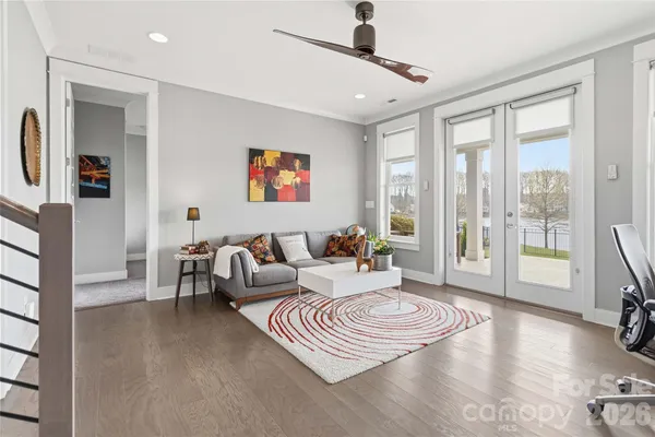 a living room with furniture and a floor to ceiling window