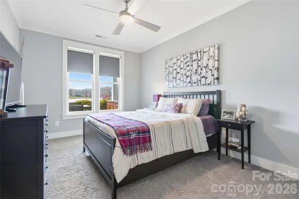 a bedroom with a bed table and window