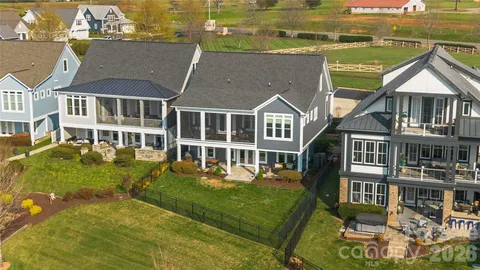 an aerial view of a house with swimming pool and a yard