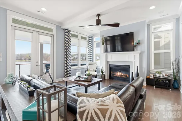 a living room with furniture a flat screen tv and a fireplace