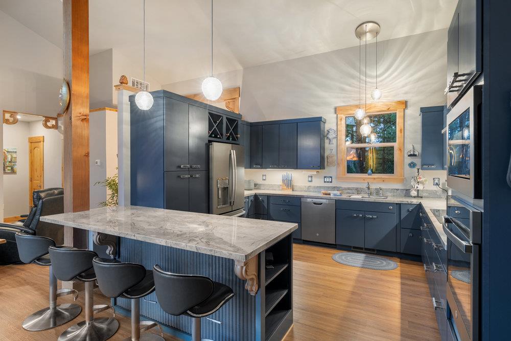 522 Night Hawk Portola, CA 96122 - Photo 18 of 54 a large kitchen with granite countertop a sink counter space stainless steel appliances and cabinets