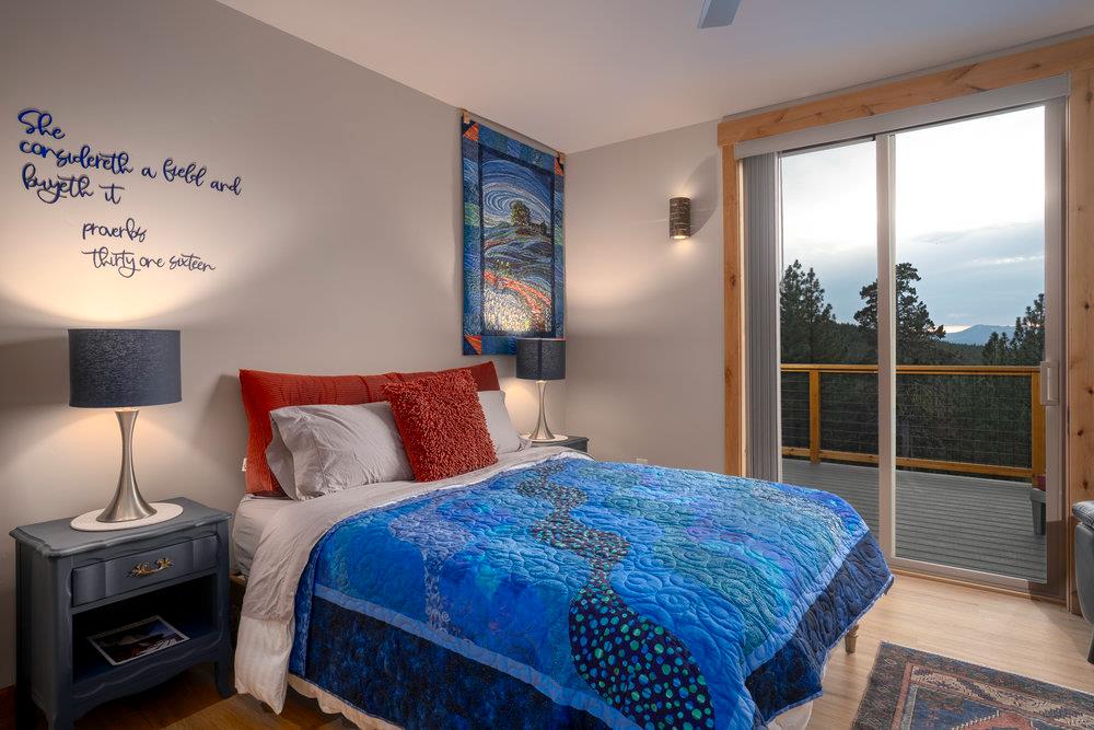 522 Night Hawk Portola, CA 96122 - Photo 24 of 54 a bedroom with a bed a lamp and a window