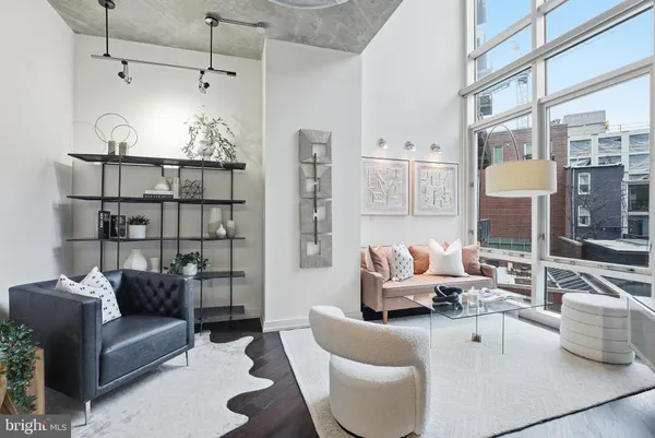 a living room with furniture and a chandelier