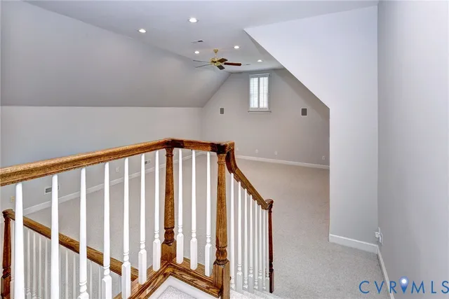 an empty room with staircase and window