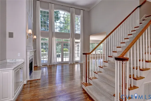 a view of an entryway with wooden floor and windows