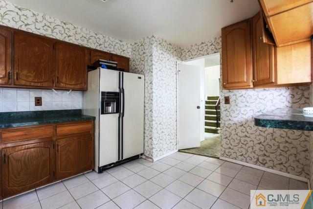 7202 Hana Road Edison, NJ 08817 - Photo 14 of 25 a kitchen with stainless steel appliances granite countertop a refrigerator and a stove