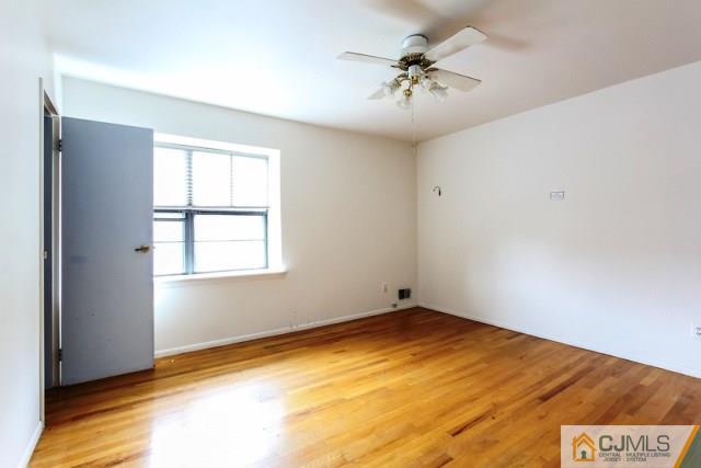 7202 Hana Road Edison, NJ 08817 - Photo 22 of 25 an empty room with a chandelier fan and windows