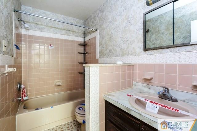 7202 Hana Road Edison, NJ 08817 - Photo 23 of 25 a bathroom with a sink a toilet and shower