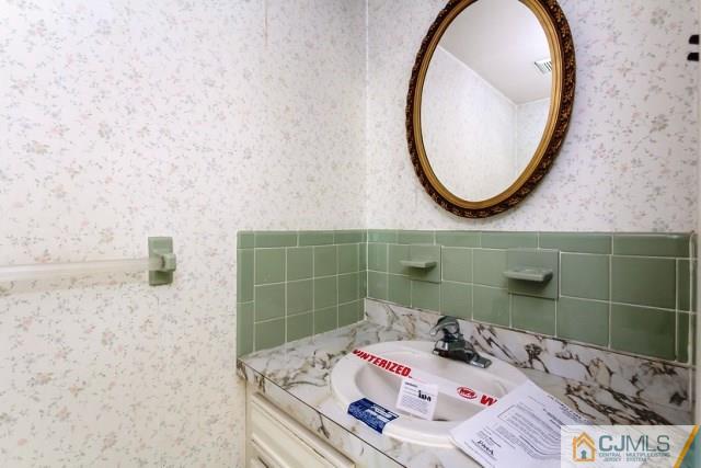 7202 Hana Road Edison, NJ 08817 - Photo 24 of 25 a bathroom with a sink and a mirror