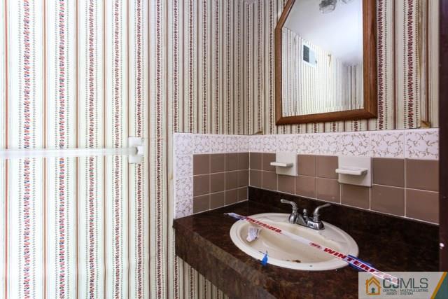 7202 Hana Road Edison, NJ 08817 - Photo 25 of 25 a bathroom with a sink and a mirror