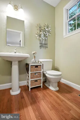 a kitchen with refrigerator a stove and chairs with wooden floor
