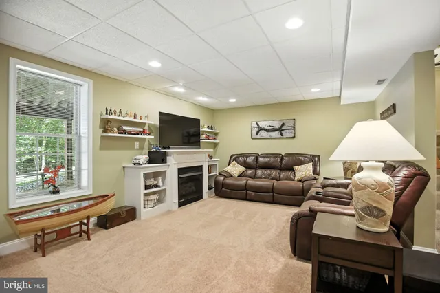 a view of a backyard with lawn chairs and a fire pit