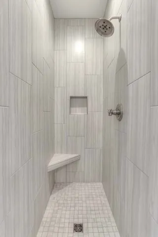 a bathroom with a toilet and a shower