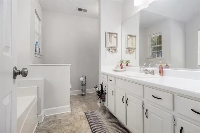 a bathroom with a double vanity sink and a mirror