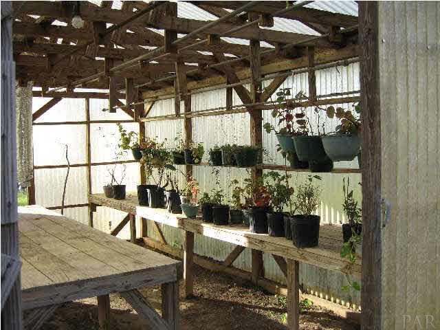 19847 Vaughn Road Seminole, AL 36574 - Photo 18 of 24 POTTING TABLES, SHELVES & HANGING RODS