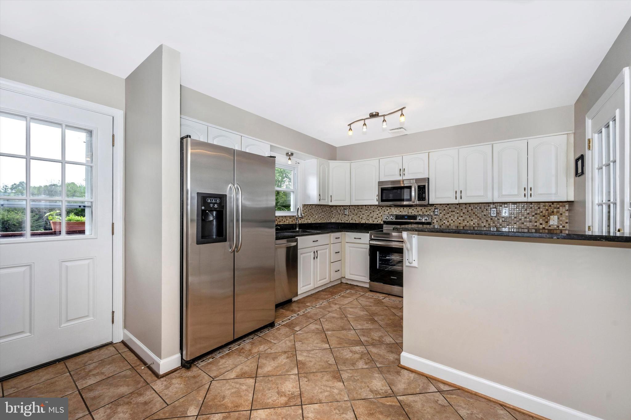 1724 Bollinger Road Westminster, MD 21157 - Photo 17 of 71 Kitchen with front entrance and back exit to deck