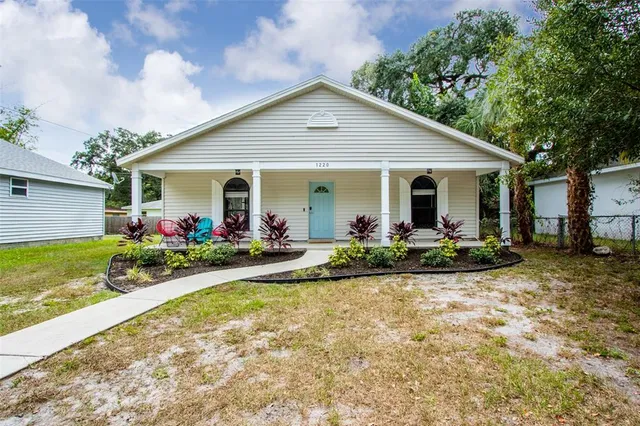 a front view of house with yard and green space