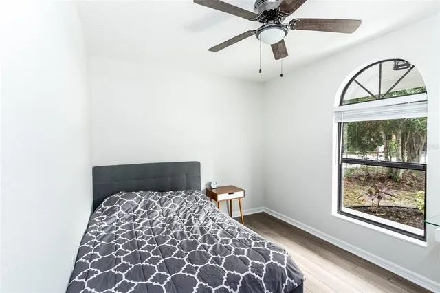 a bedroom with a bed and a window