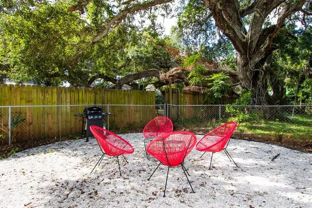 a backyard with a table and chairs
