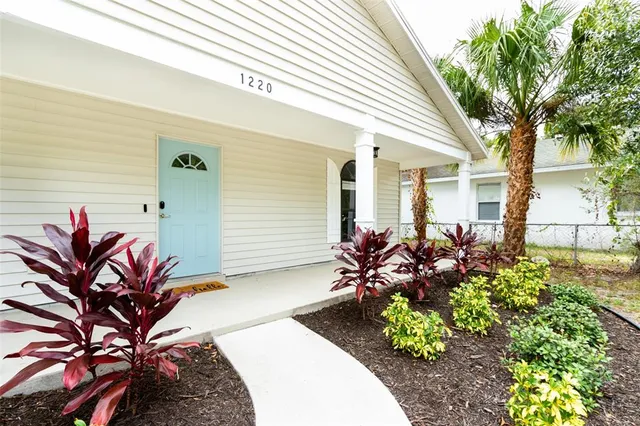a front view of a house with a garden