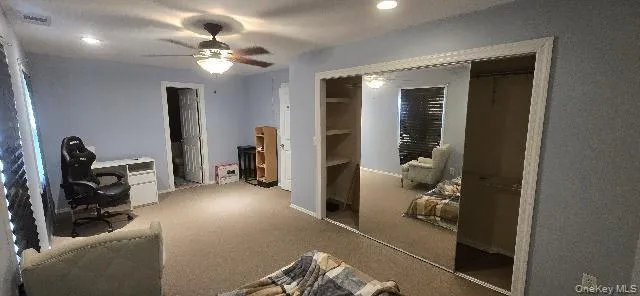 a view of a livingroom with furniture and workspace
