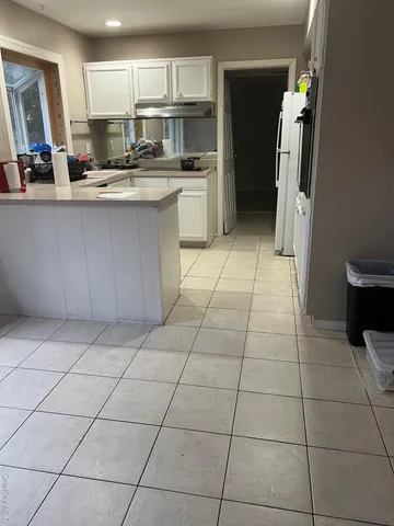 a kitchen with stainless steel appliances granite countertop a sink and a refrigerator