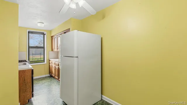 a view of a hallway with a refrigerator