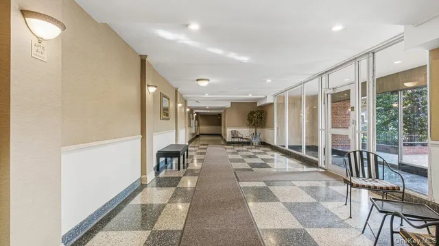 a view of a hallway with wooden floor and furniture