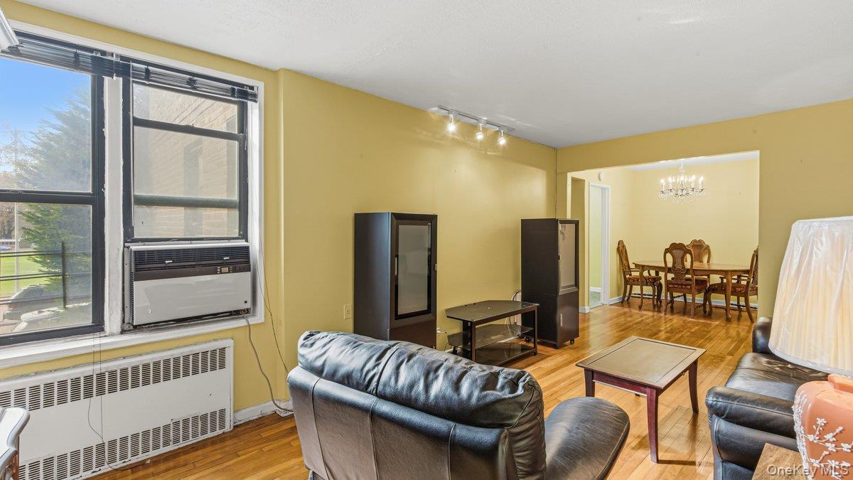 83-35 139th Street, Unit 1D Queens, NY 11435 - Photo 2 of 20 a living room with furniture and a window