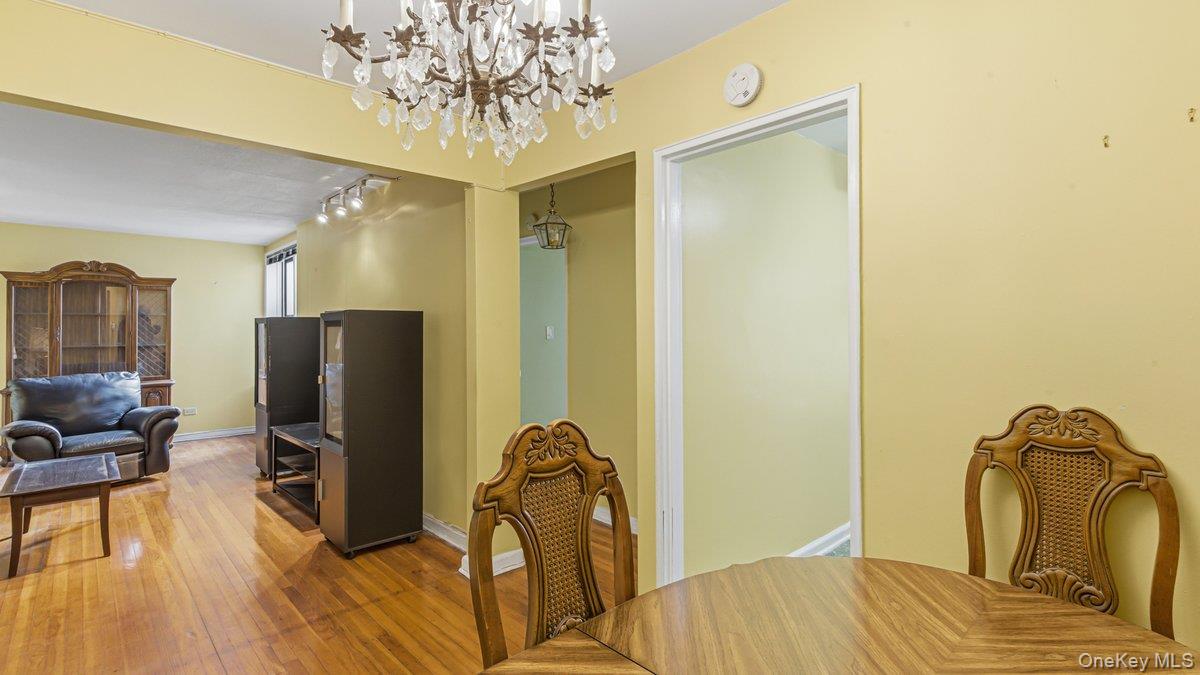 83-35 139th Street, Unit 1D Queens, NY 11435 - Photo 5 of 20 a bedroom with a bed and a chandelier