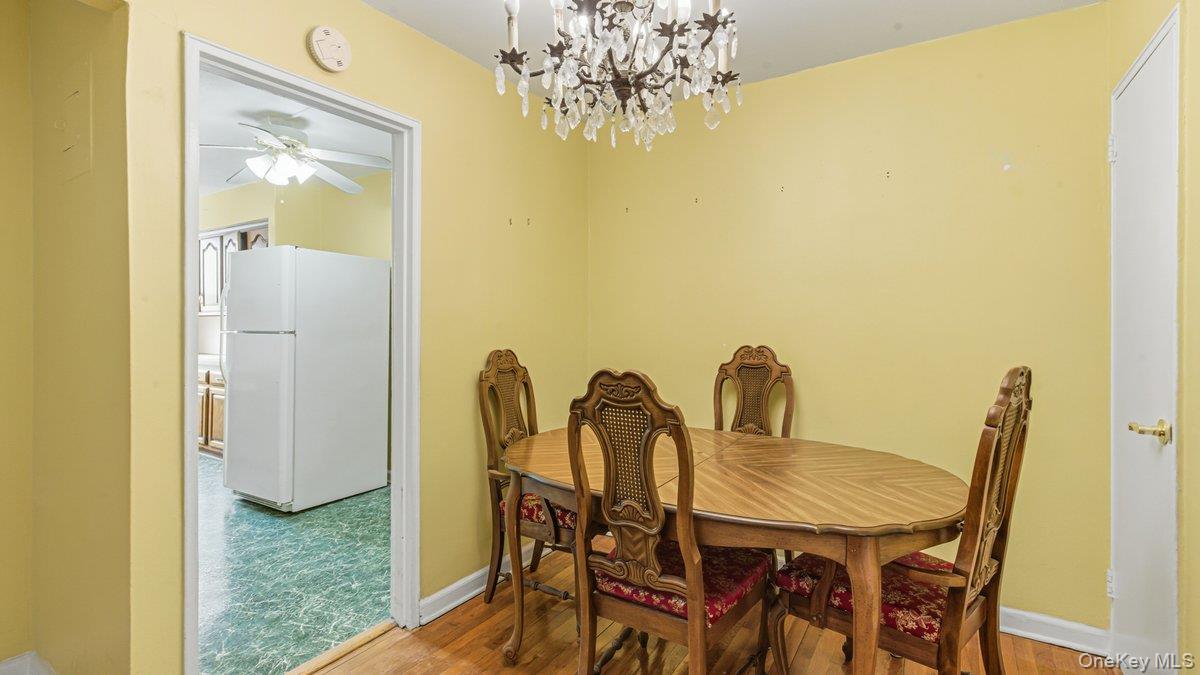 83-35 139th Street, Unit 1D Queens, NY 11435 - Photo 7 of 20 a view of a dining room with furniture and chandelier