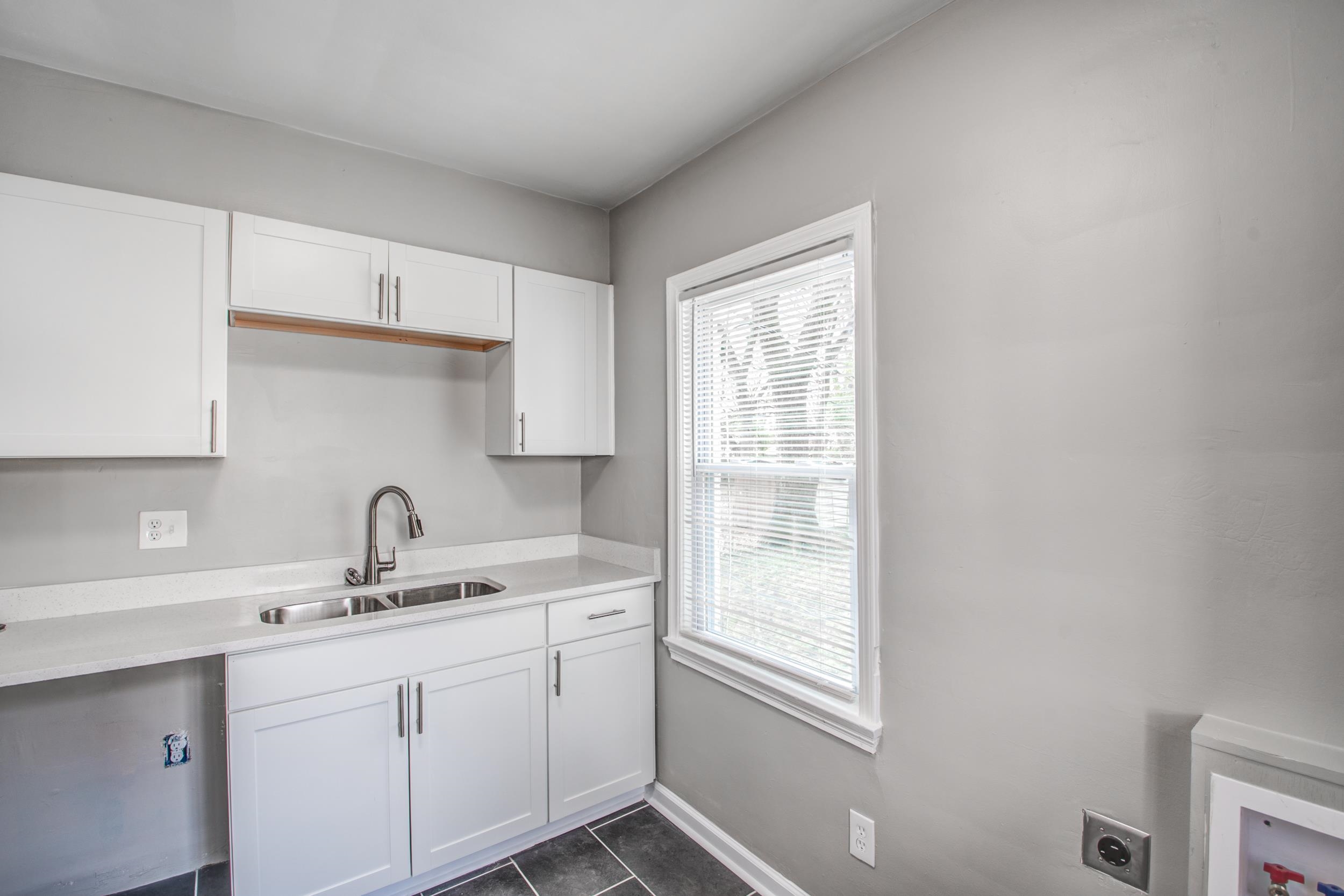 835 Watson Street Memphis, TN 38111 - Photo 11 of 24 Kitchen with white cabinets and dark tile patterned floors