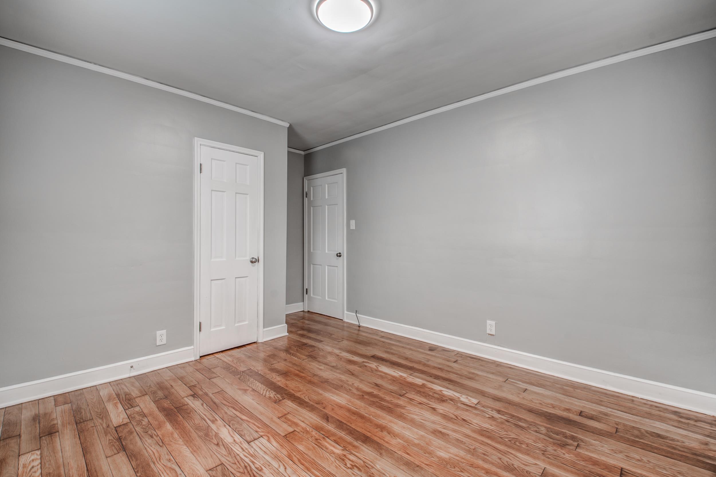 835 Watson Street Memphis, TN 38111 - Photo 12 of 24 Spare room with crown molding and light wood finished floors