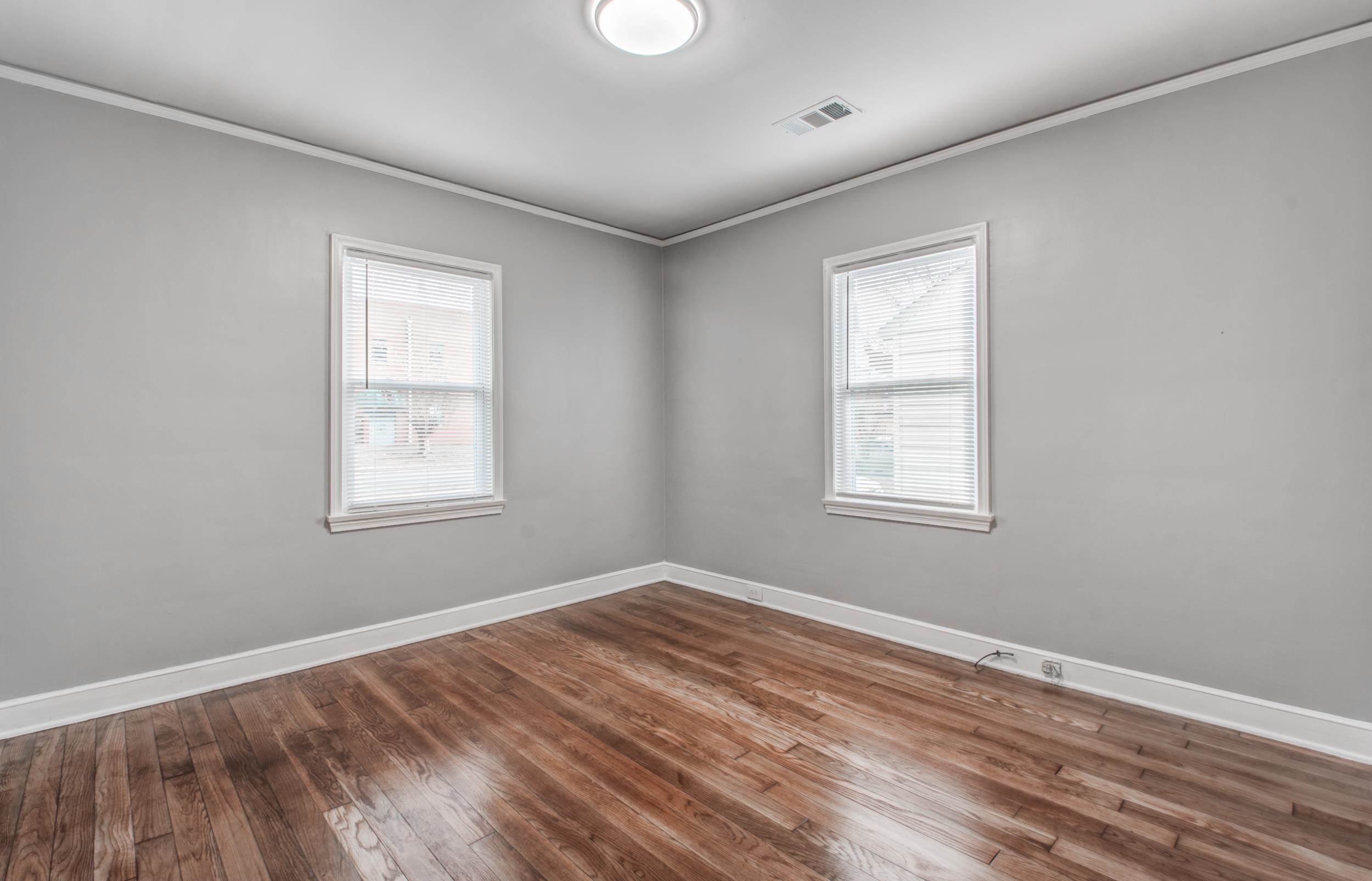 835 Watson Street Memphis, TN 38111 - Photo 16 of 24 Empty room featuring ornamental molding and dark wood-type flooring