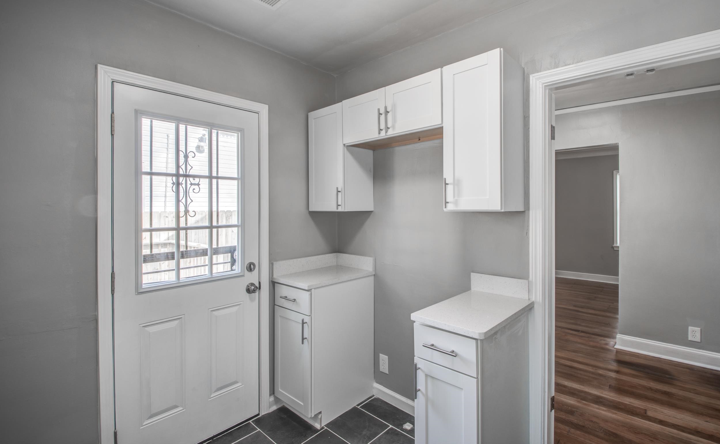 835 Watson Street Memphis, TN 38111 - Photo 17 of 24 Laundry room with baseboards and dark wood-style floors