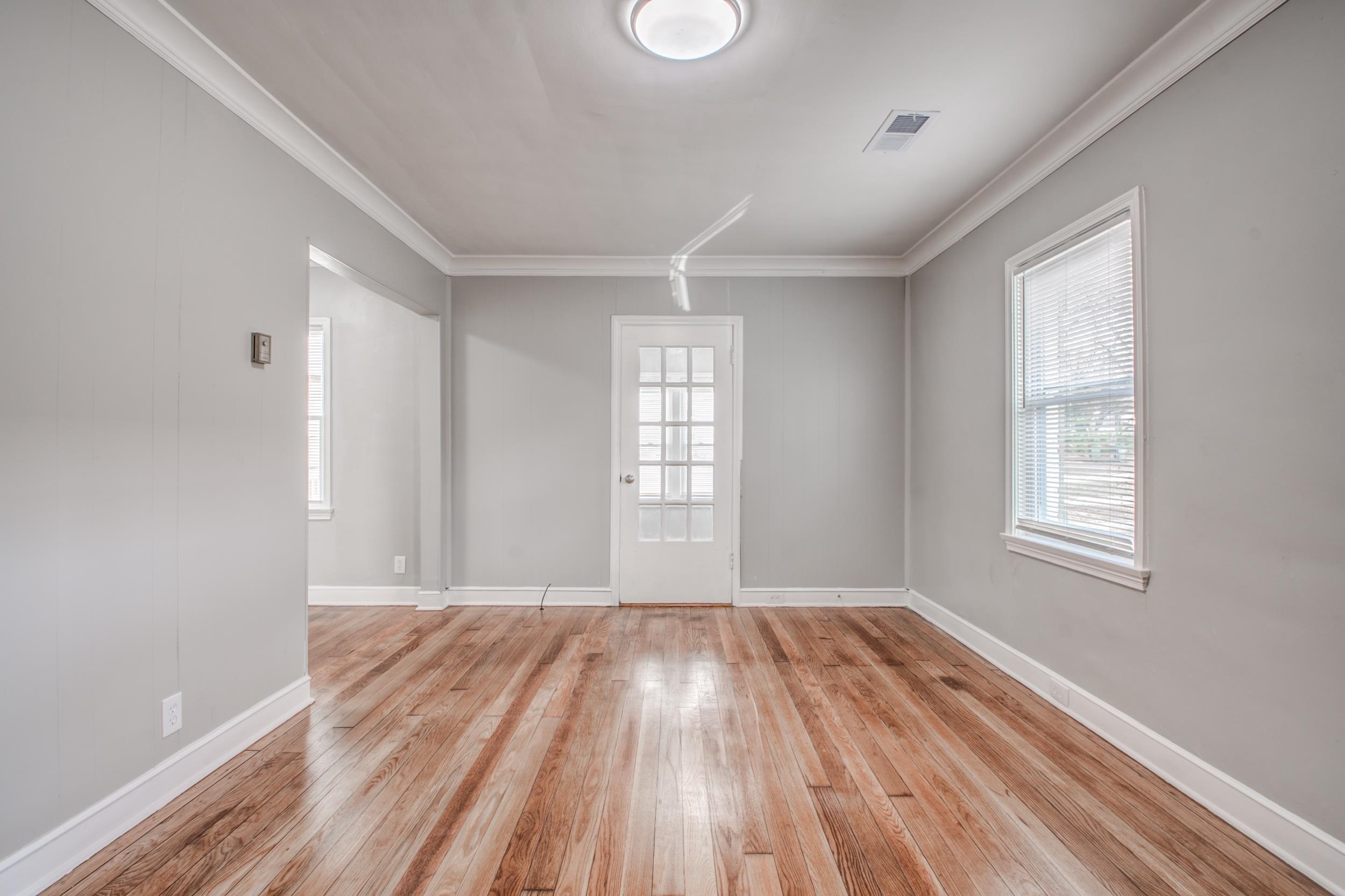 835 Watson Street Memphis, TN 38111 - Photo 3 of 24 Unfurnished room featuring light wood finished floors, ornamental molding, and plenty of natural light
