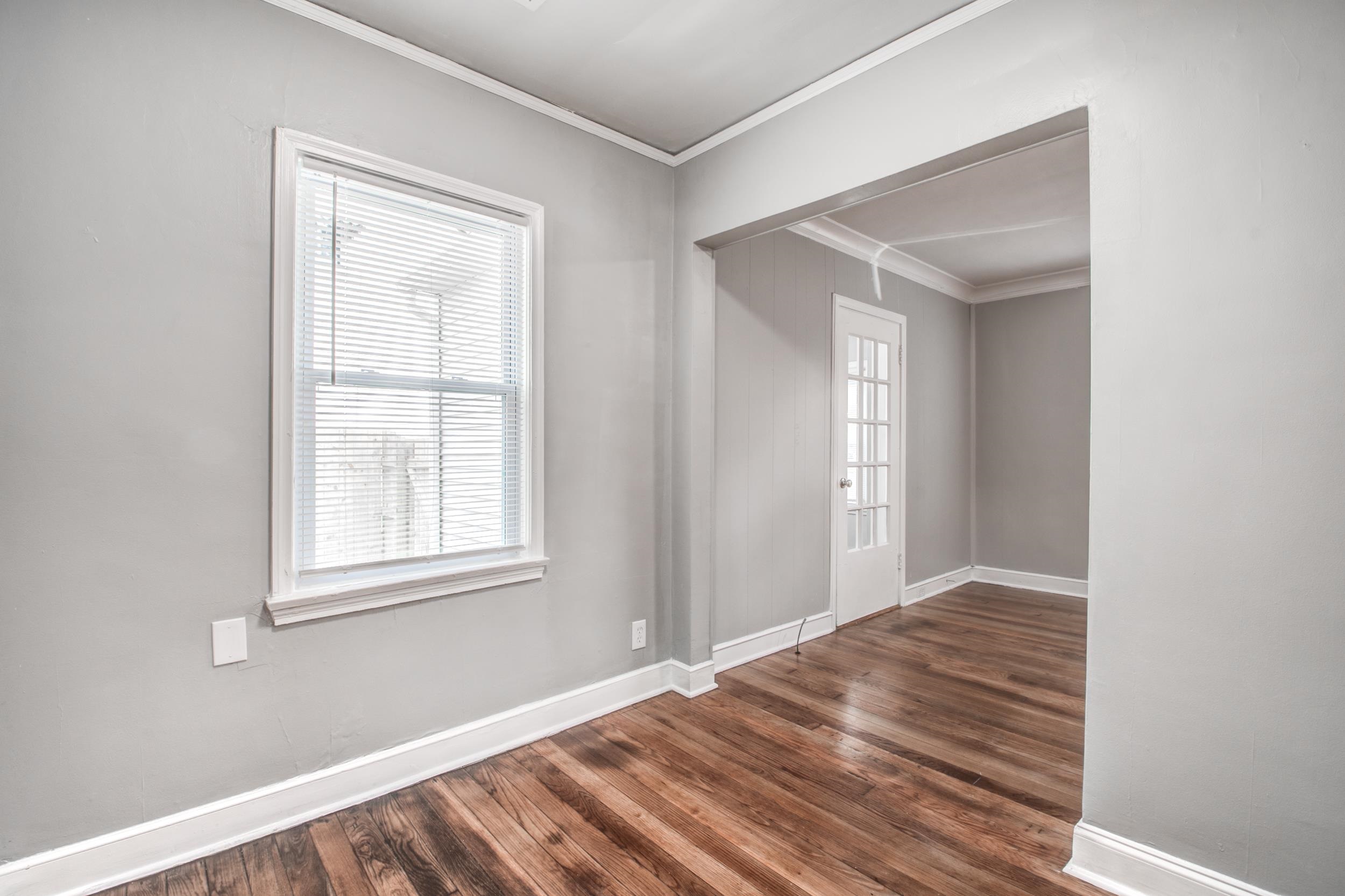 835 Watson Street Memphis, TN 38111 - Photo 7 of 24 Empty room with crown molding and dark wood finished floors