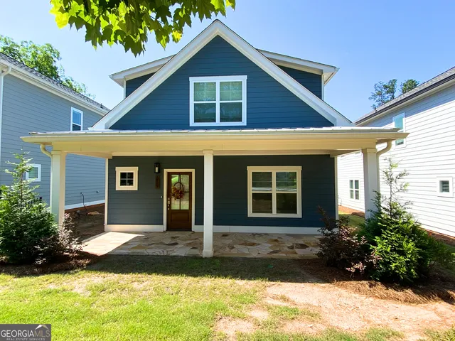a front view of a house with a yard and porch