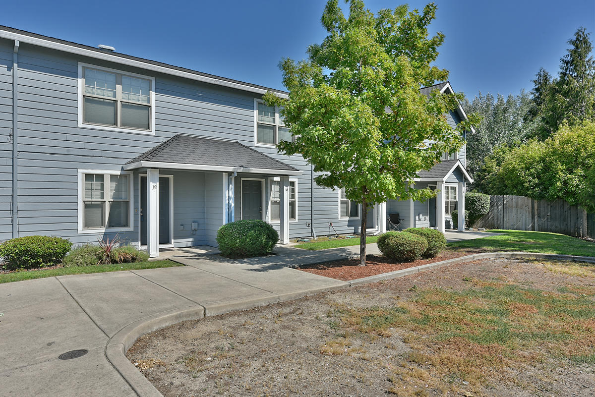 450 Midway Road, Unit 39 Medford, OR 97501 - Photo 2 of 21 a front view of a house with a yard and garage