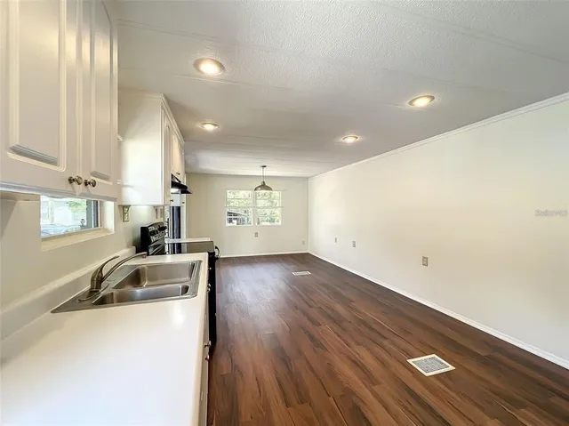 a large kitchen with a sink and stainless steel appliances