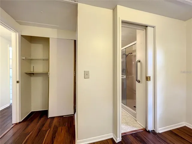 a view of an empty room and wooden floor