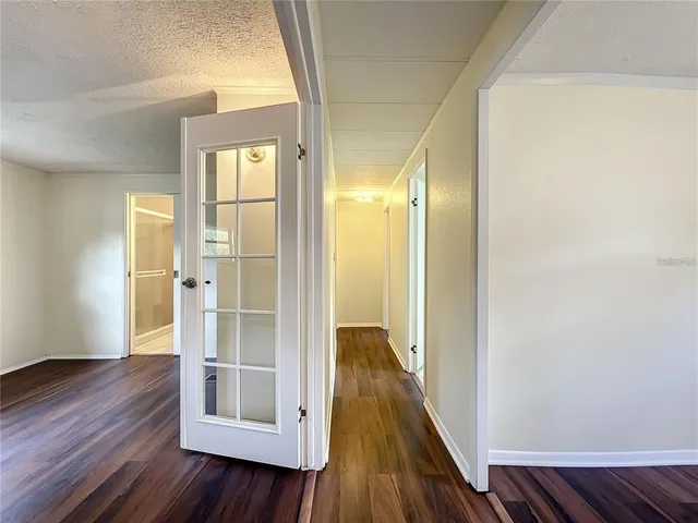 a white house that has a tree in front of it